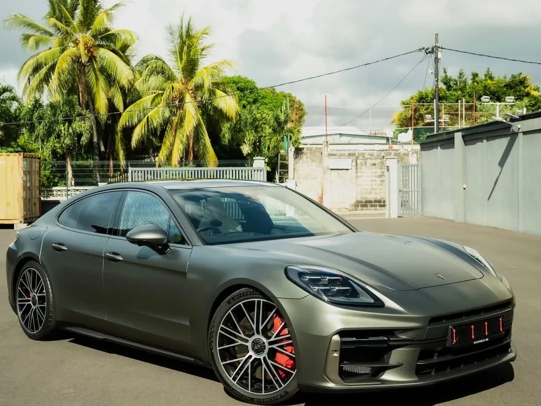A Porsche Panamera Turbo in satin dark green, in profile, with red brake calipers