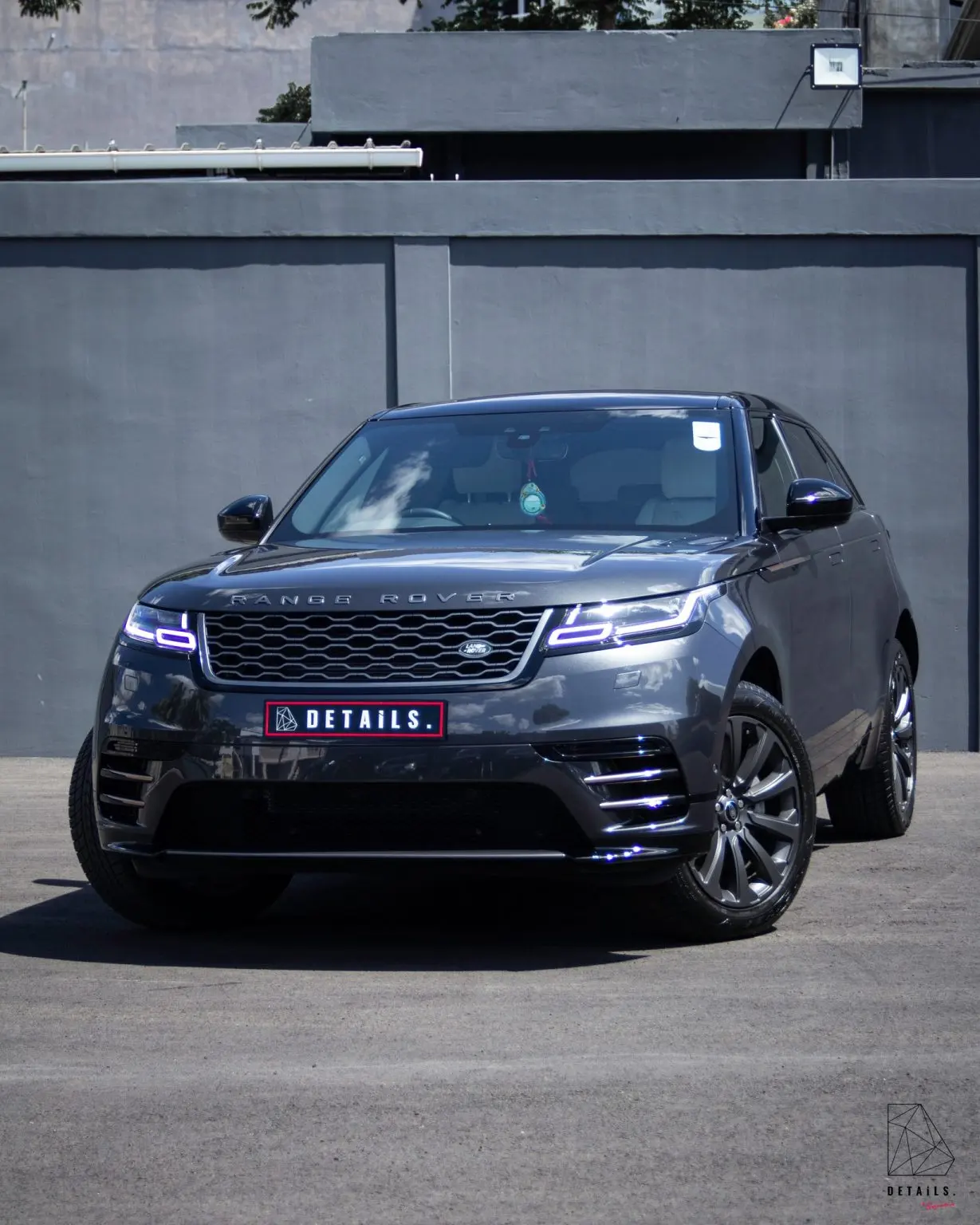 A dark grey Range Rover Velar with a DETAILS number plate